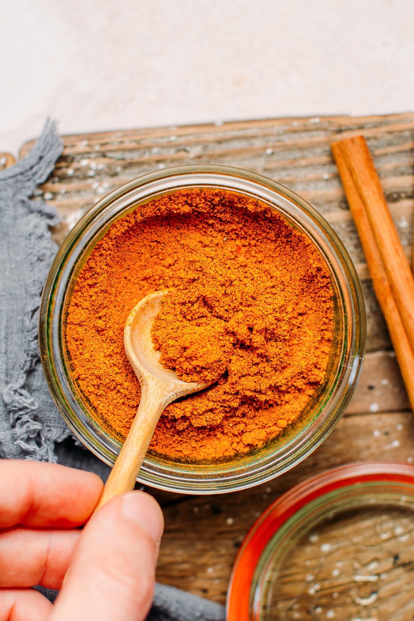Hand holding a spoon of Vietnamese curry powder.