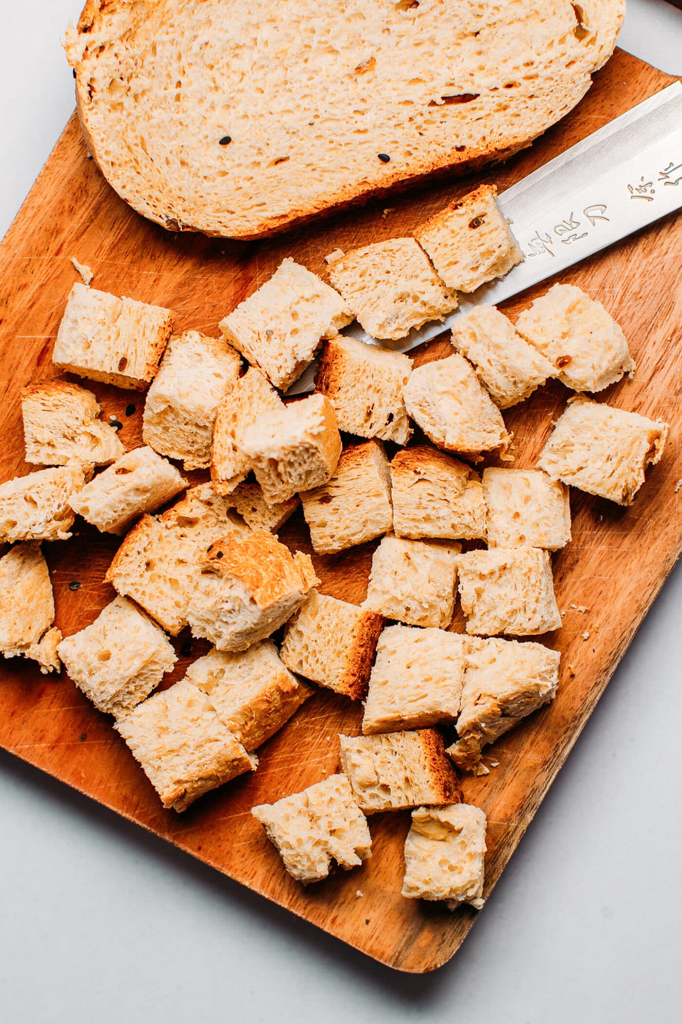 Diced bread on a baking sheet.
