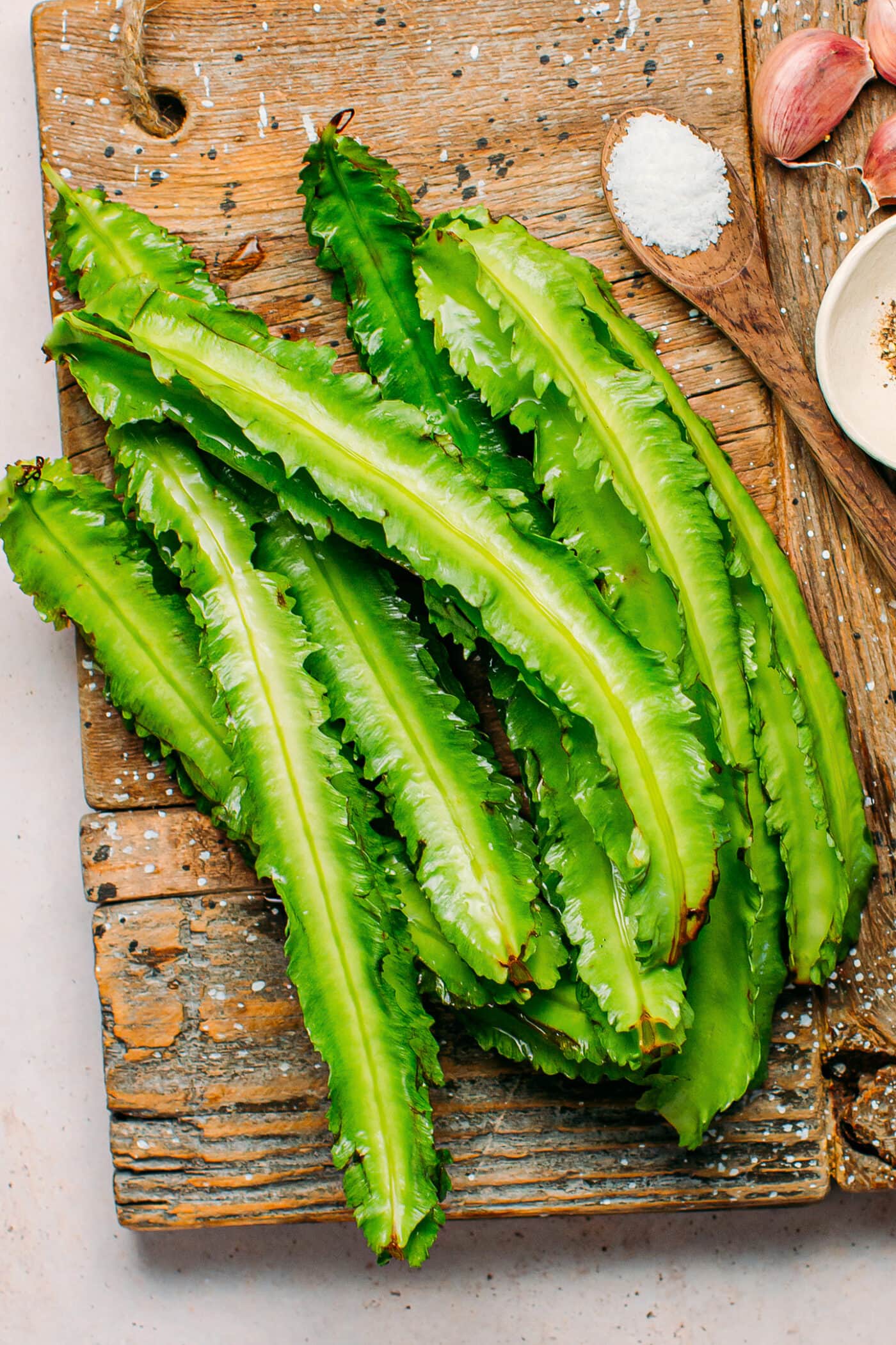 Winged beans on a wooden board.