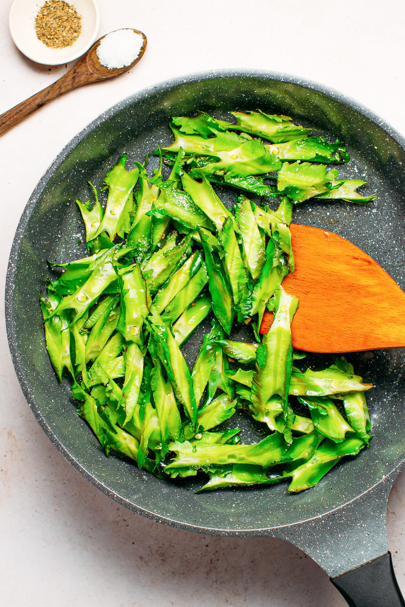 Sautéed winged beans in a skillet.