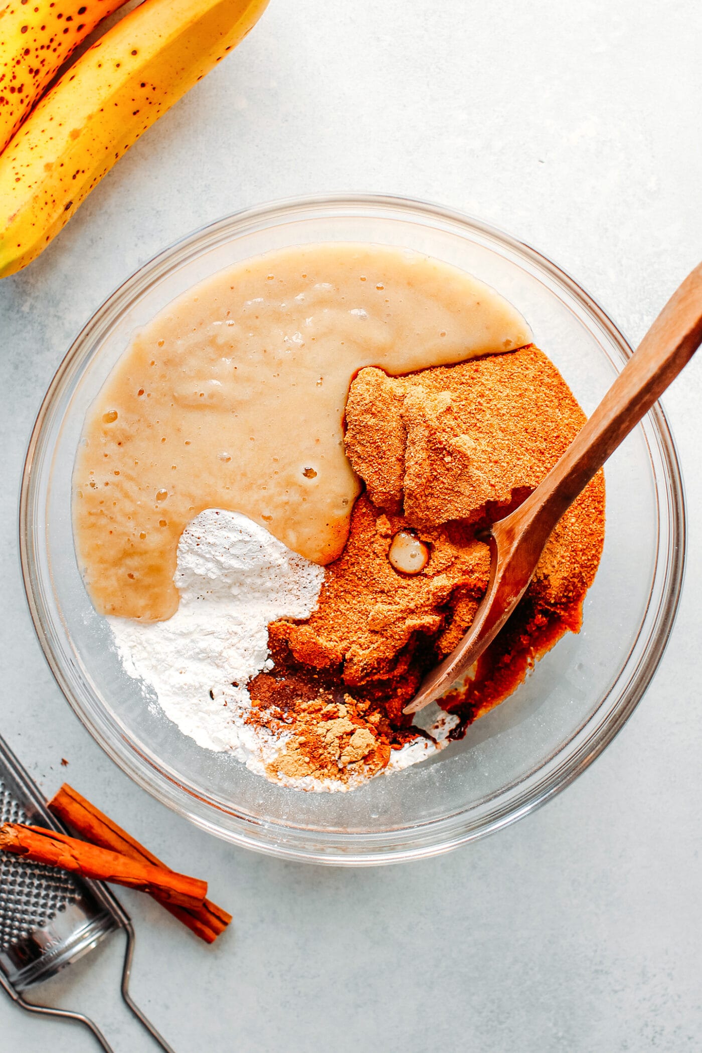 Whisking together flour, sugar, and mashed bananas.