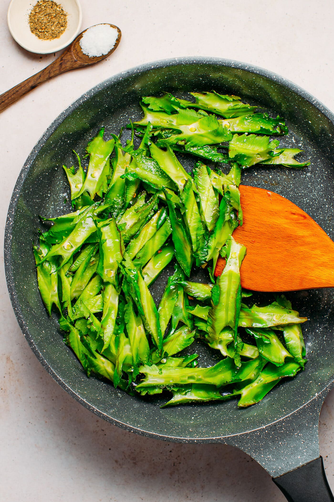 Sautéed winged beans in a skillet.