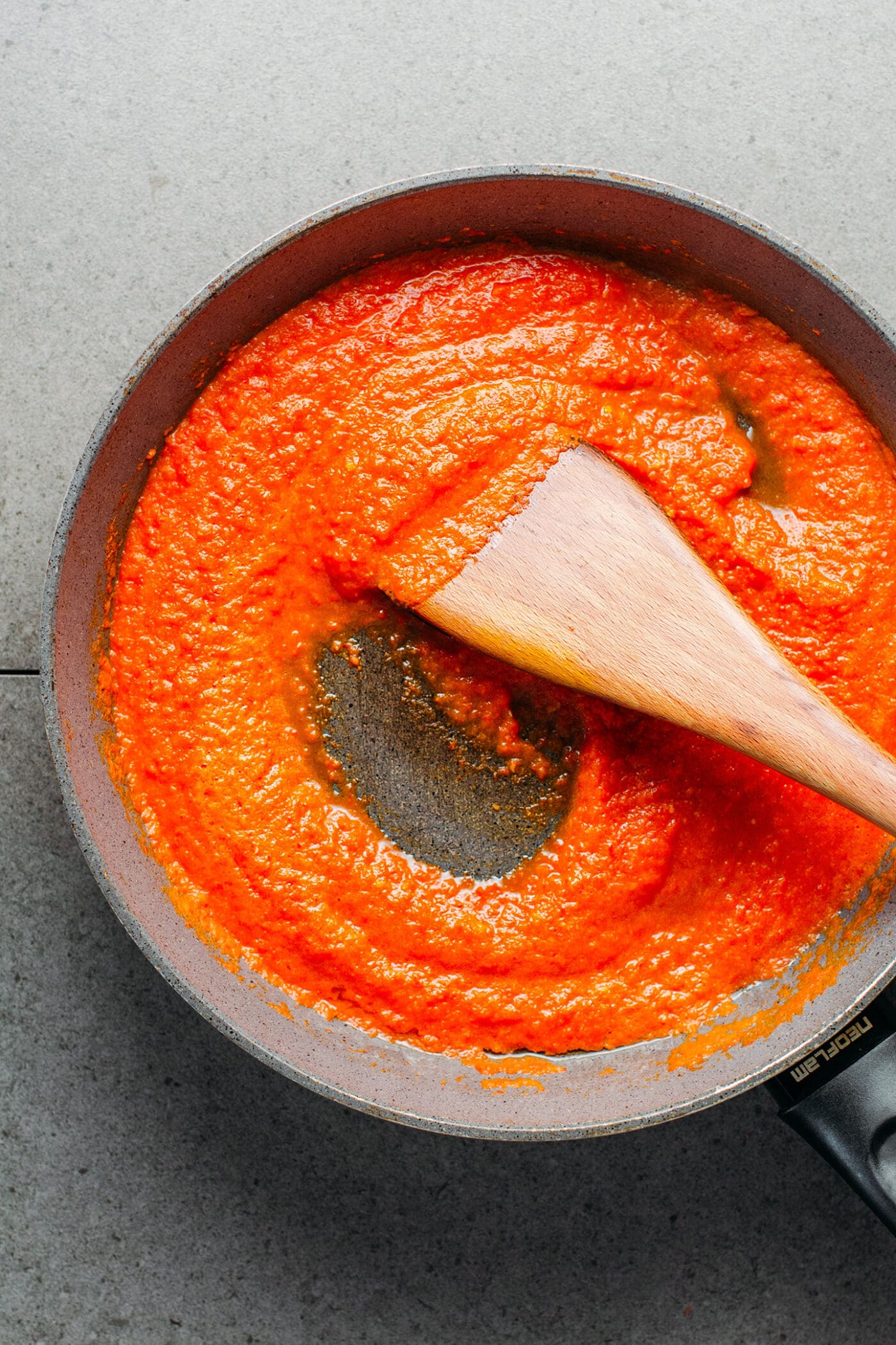 Cooking chili sauce in a skillet.