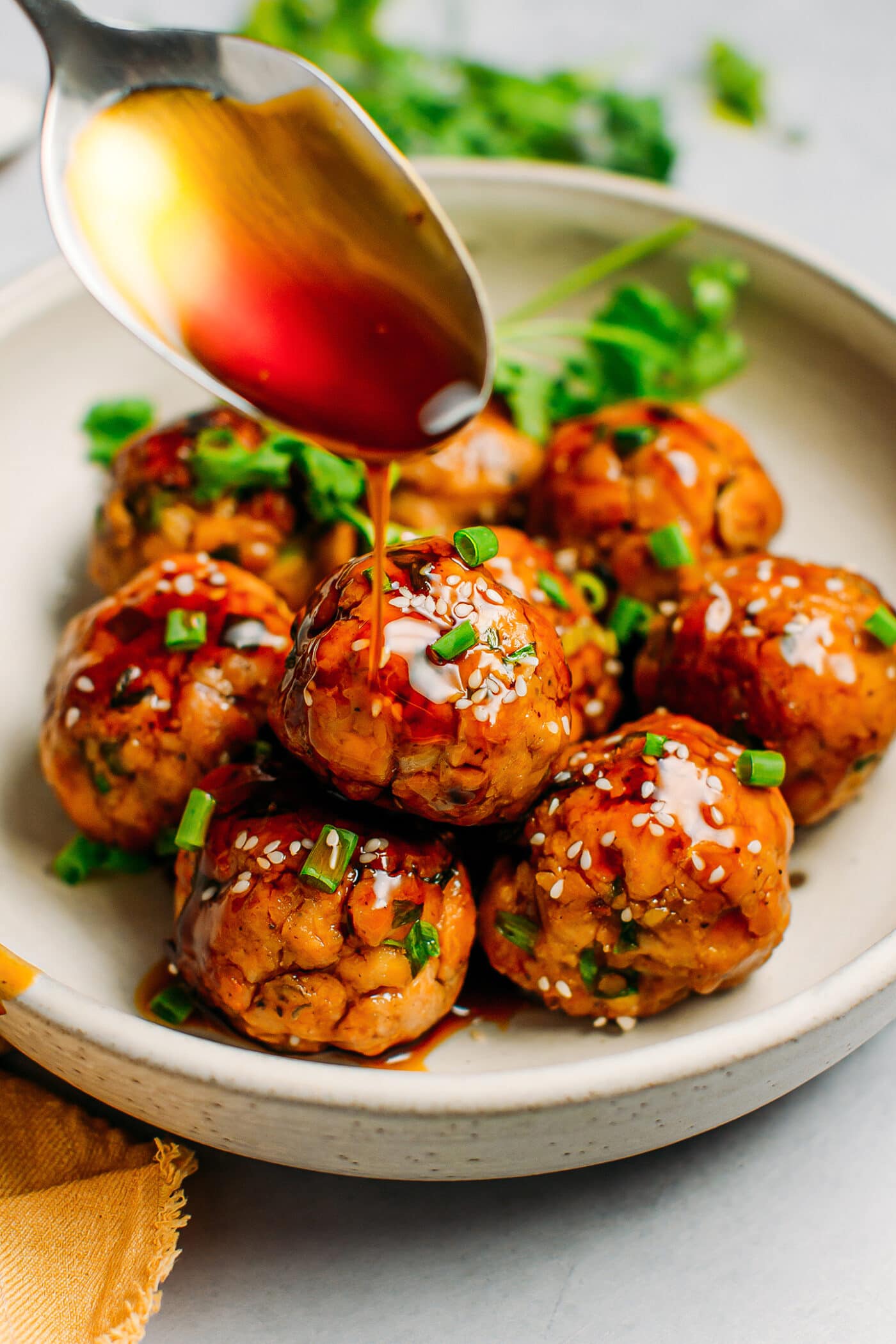 Tempeh meatballs coated with teriyaki sauce.