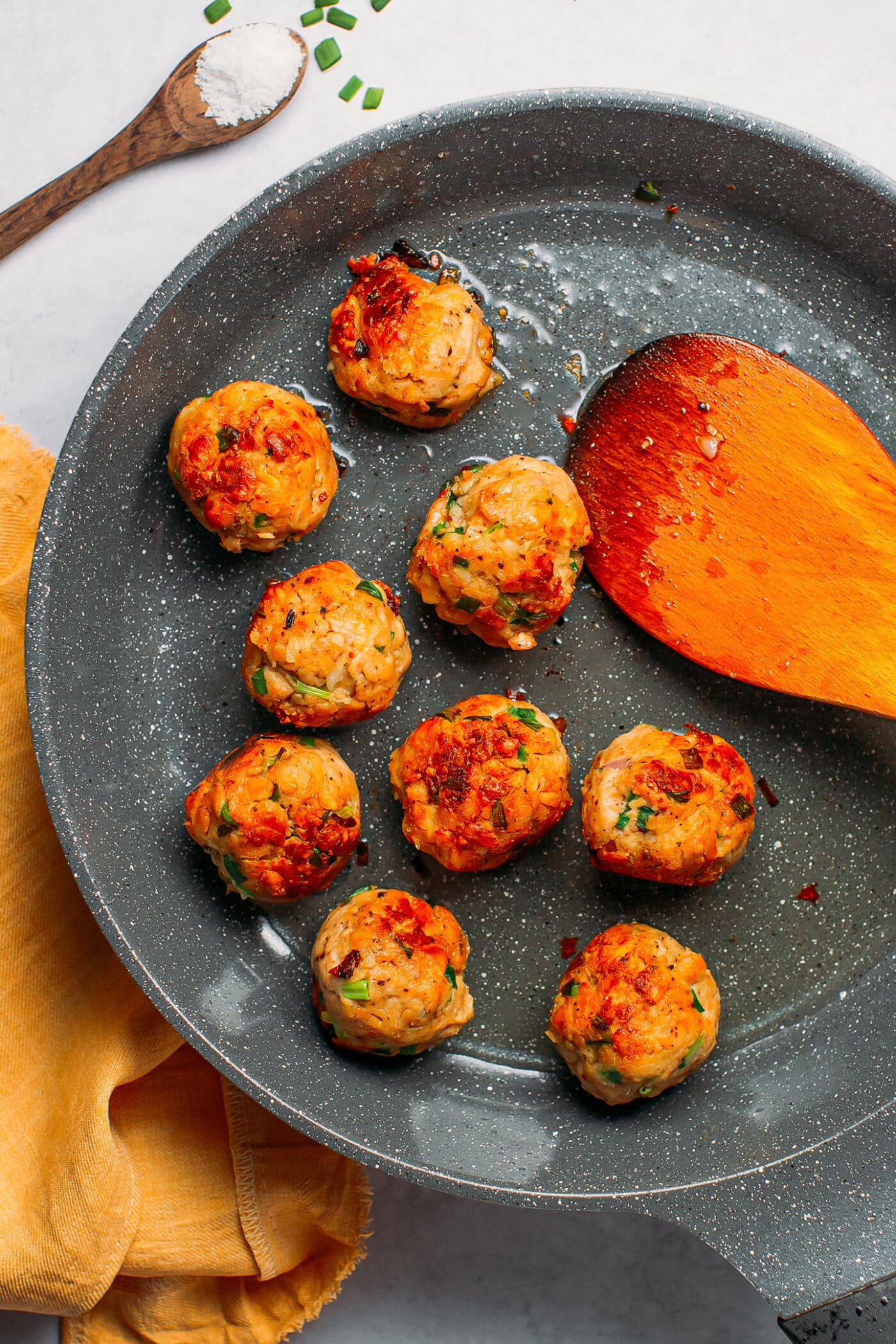 Sautéed tempeh meatballs in a skillet.