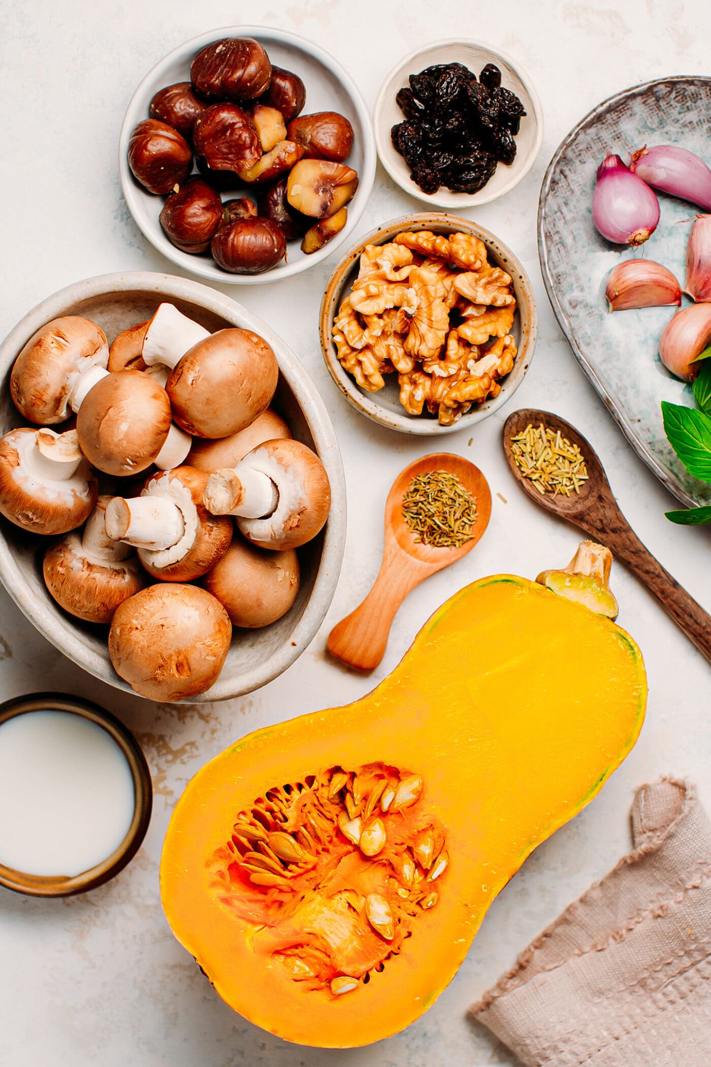 Ingredients like butternut squash, mushrooms, walnuts, chestnuts, garlic, and shallots.