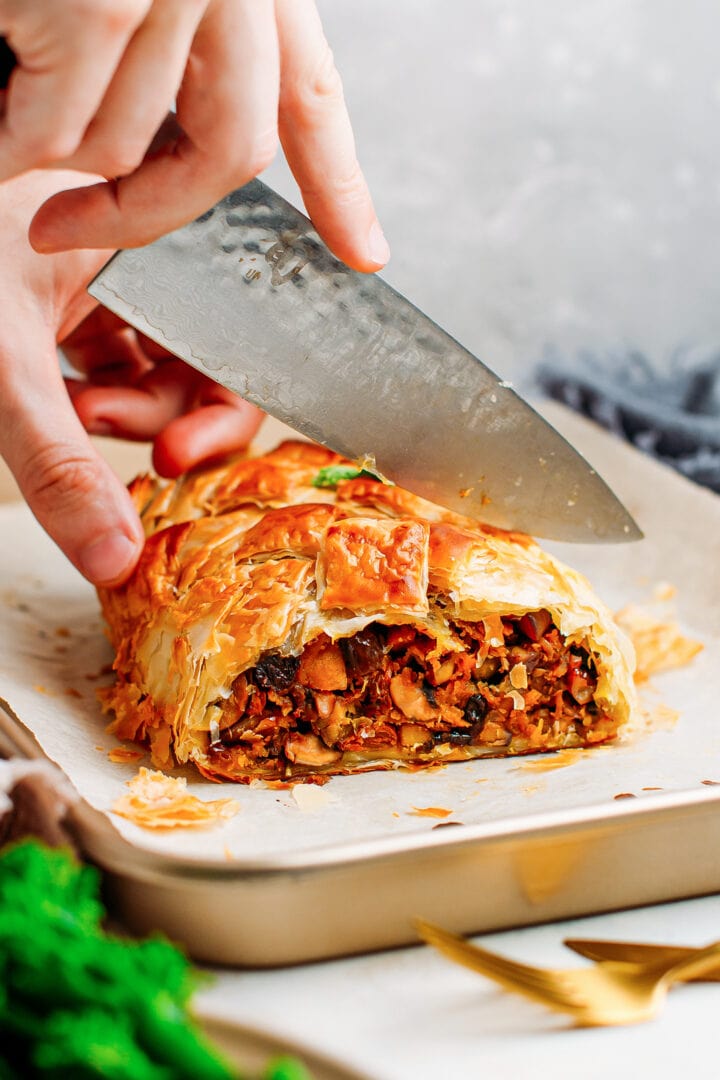 Cutting through a vegetable Wellington.