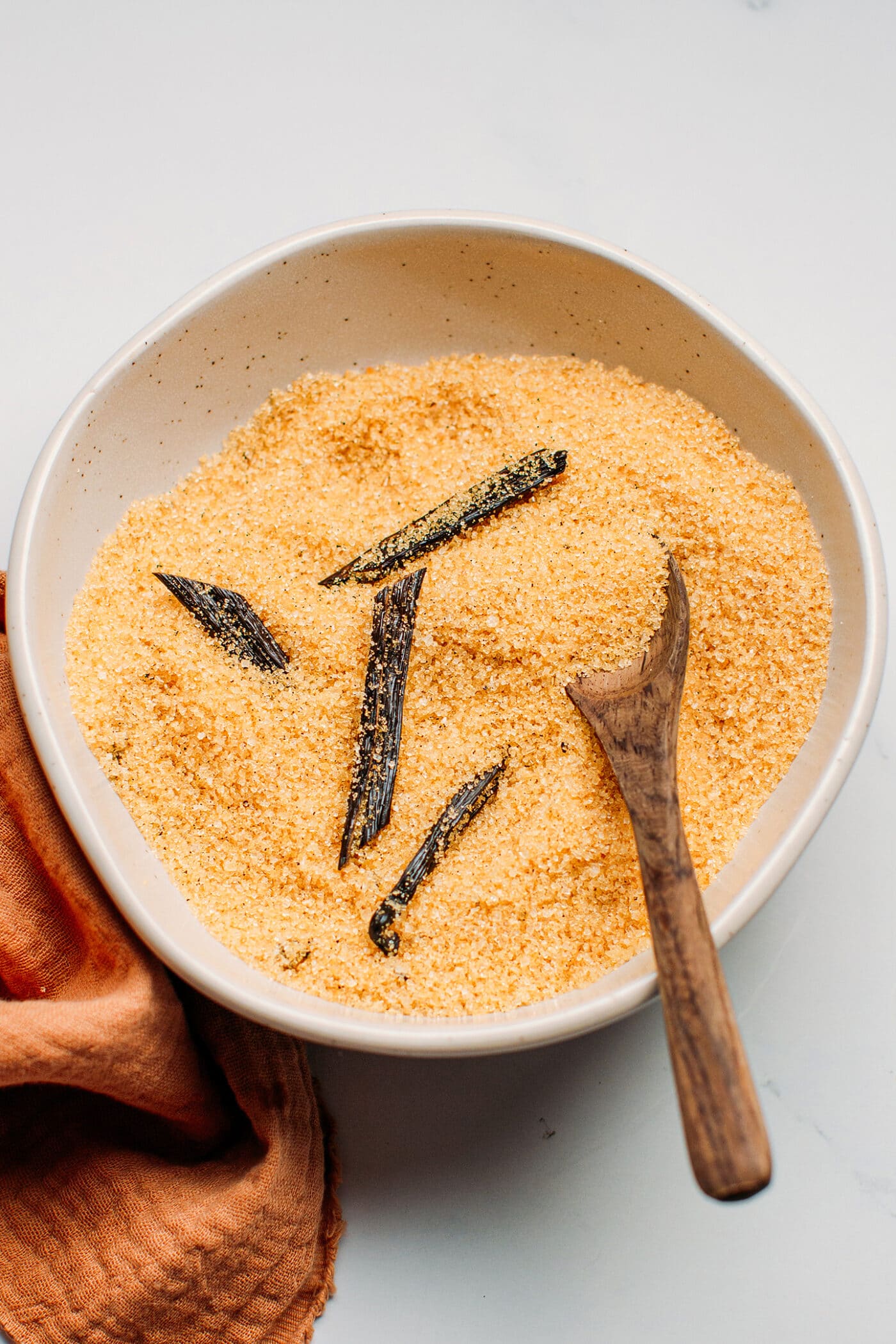 Sliced vanilla beans in light brown sugar.