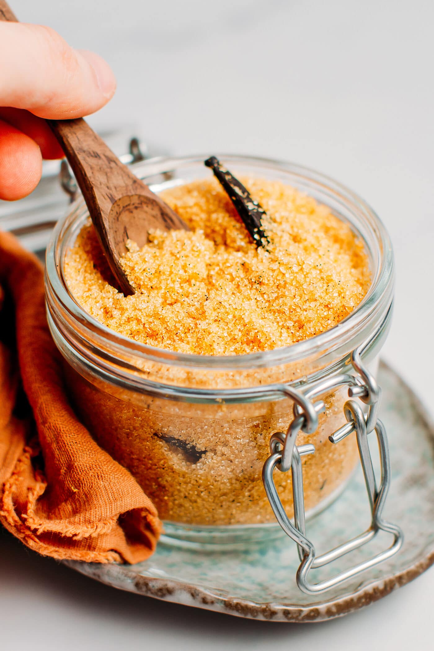 Homemade vanilla sugar in a glass jar.