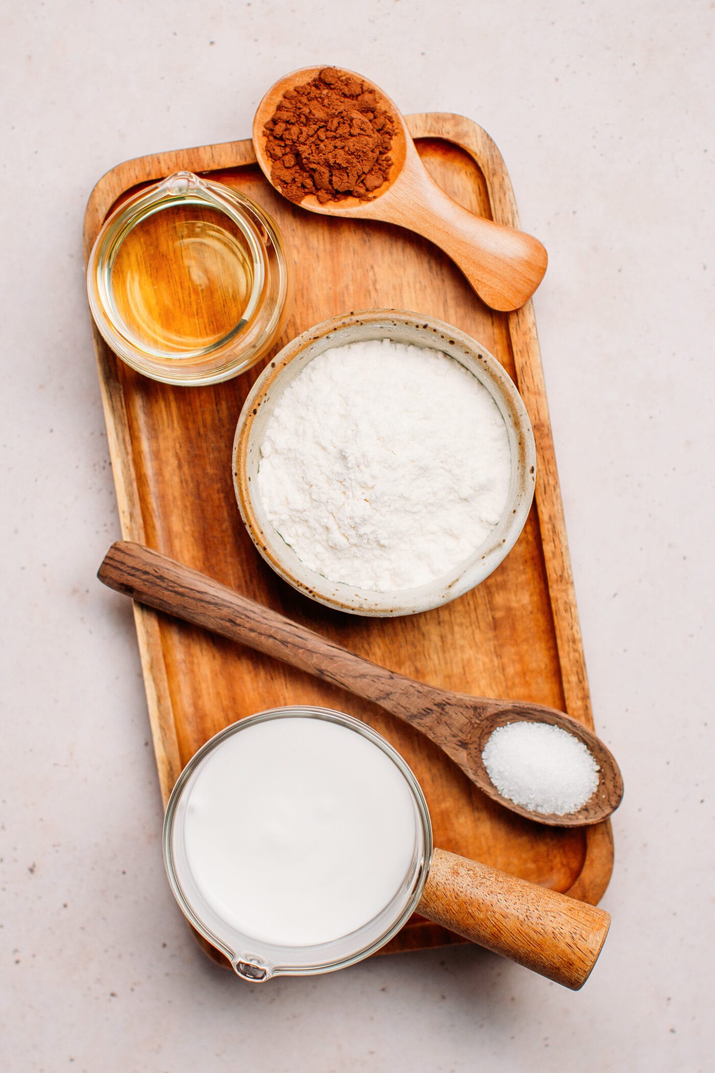 Ingredients like flour, cacao powder, oil, almond milk, and sugar.