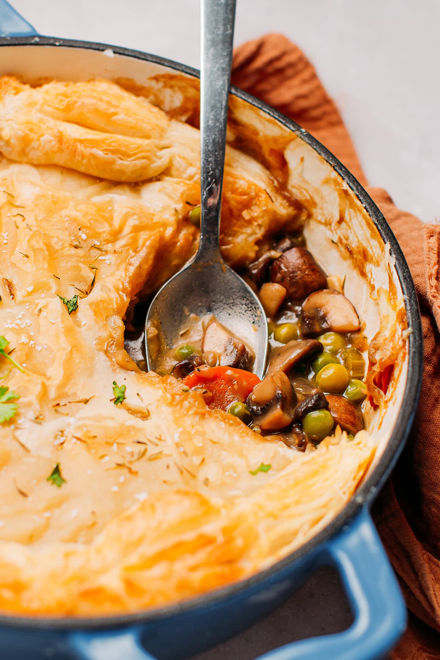 Close up of mushroom pot pie with carrots and green peas.