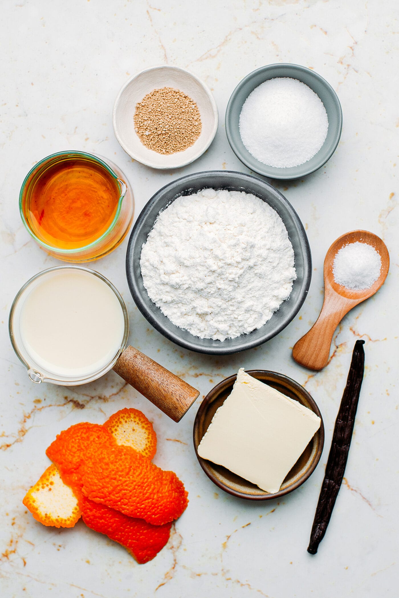 Ingredients like flour, butter, orange peel, rum, and vanilla bean.