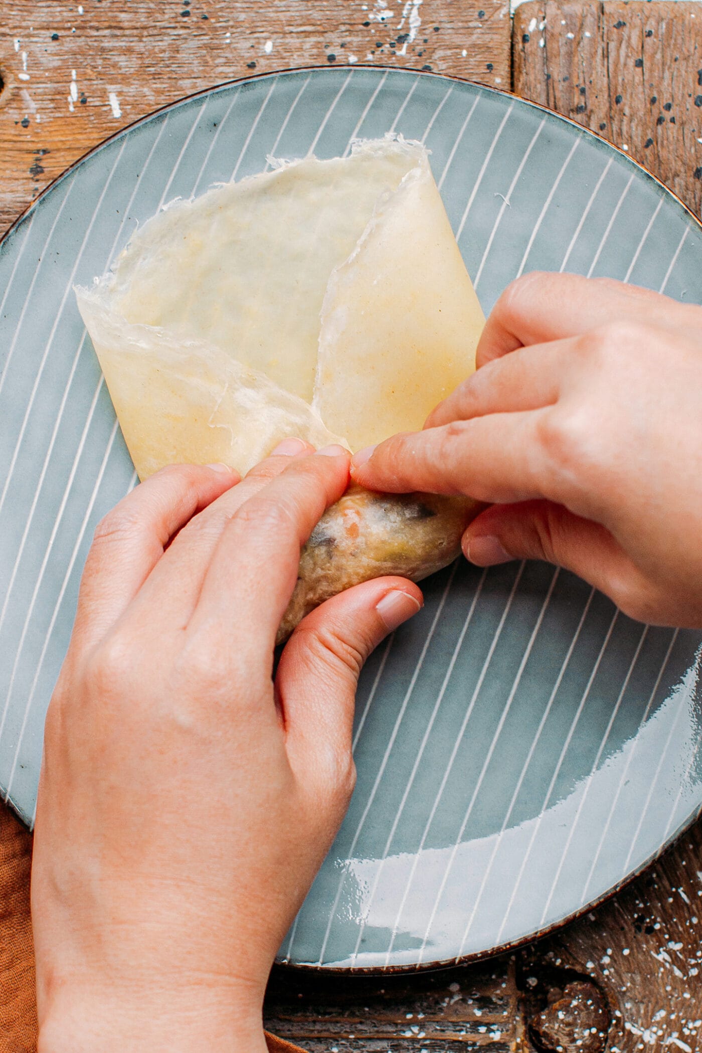 Rolling out an egg roll.