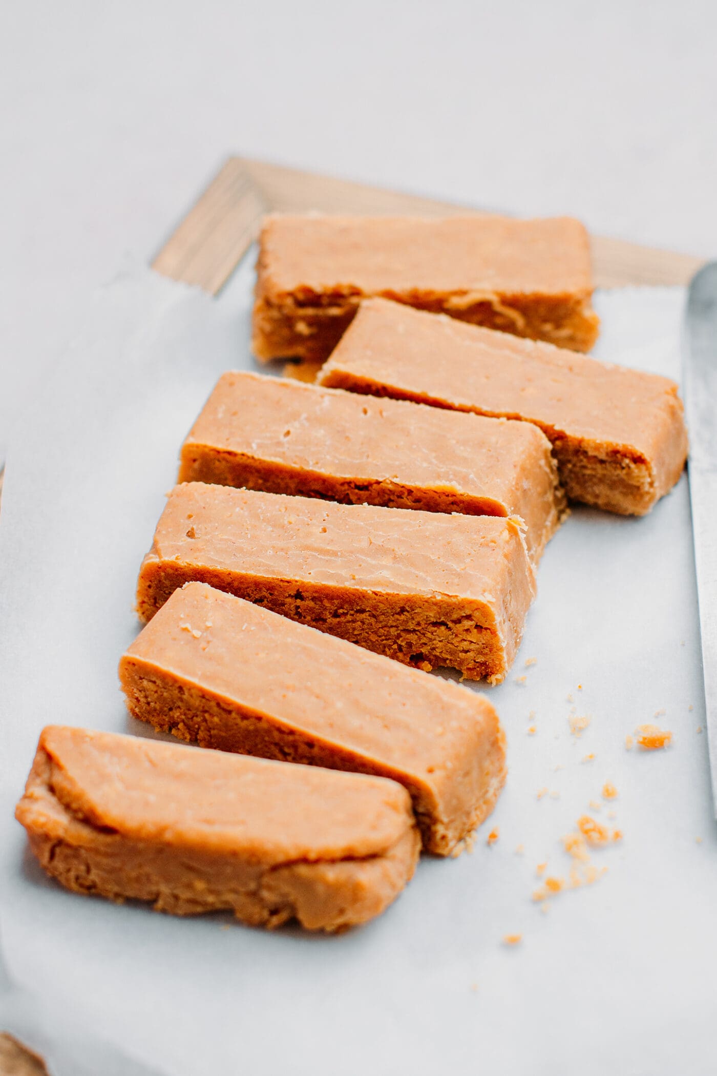 Sliced peanut butter candy bars on a cutting board.