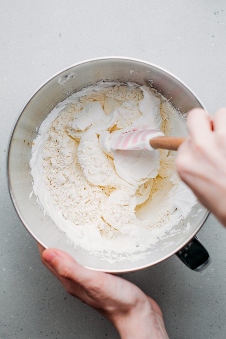 Folding flour into whipped aquafaba.