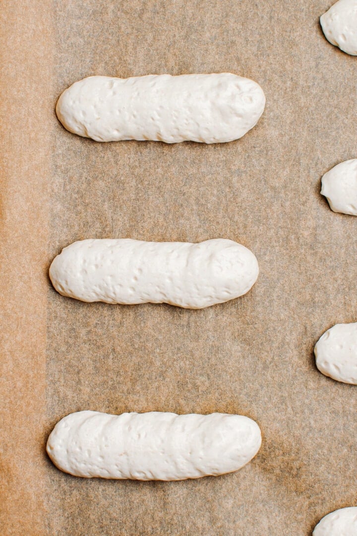 Piped vegan meringue on a baking sheet.
