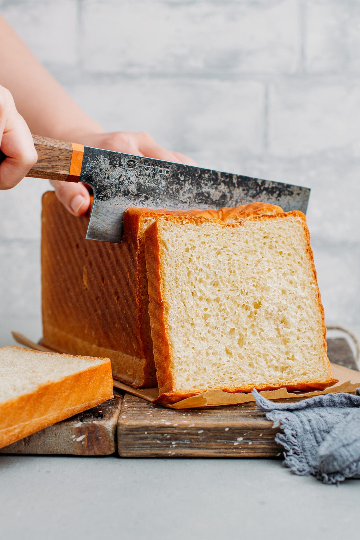 Slicing a loaf of sandwich bread.
