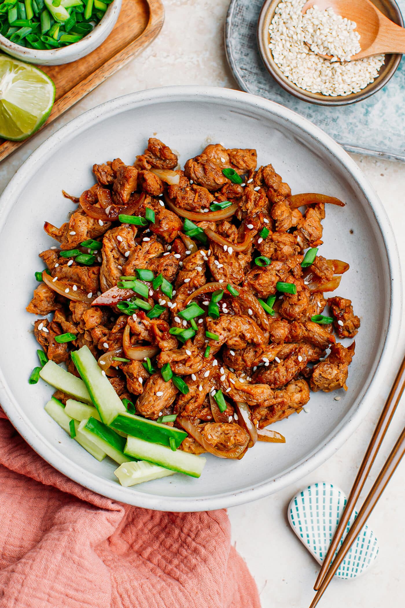 Vegan bulgogi soy curls topped with green onions and sesame seeds.
