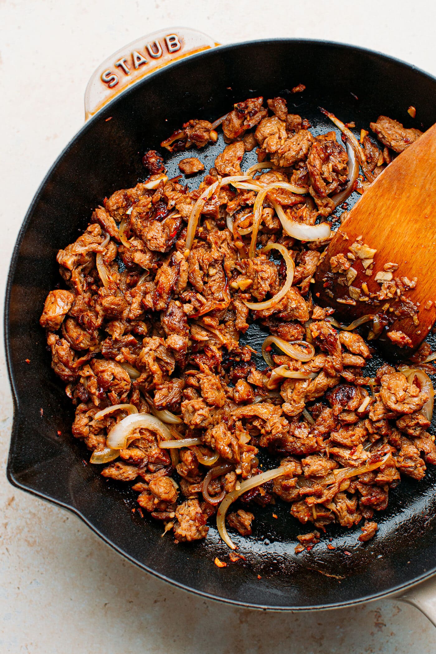 Soy curls with onions and bulgogi sauce in a skillet.