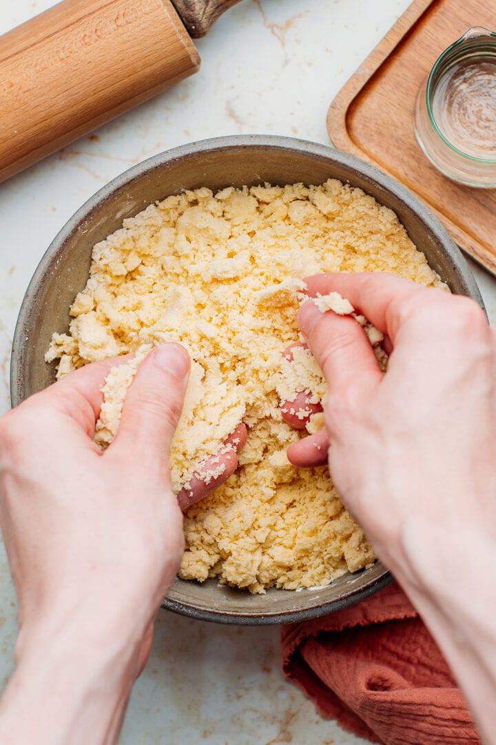 Sanding butter and flour in a bowl.