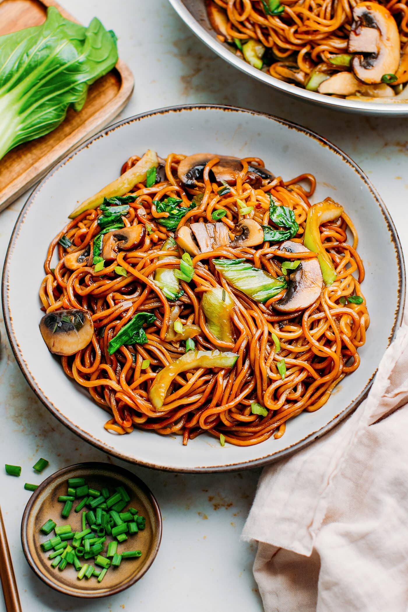 Vegetable Lo Mein with mushrooms and pak choi on a plate.