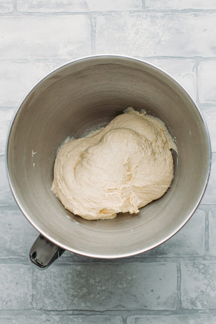 Dough in the bowl of a stand mixer.