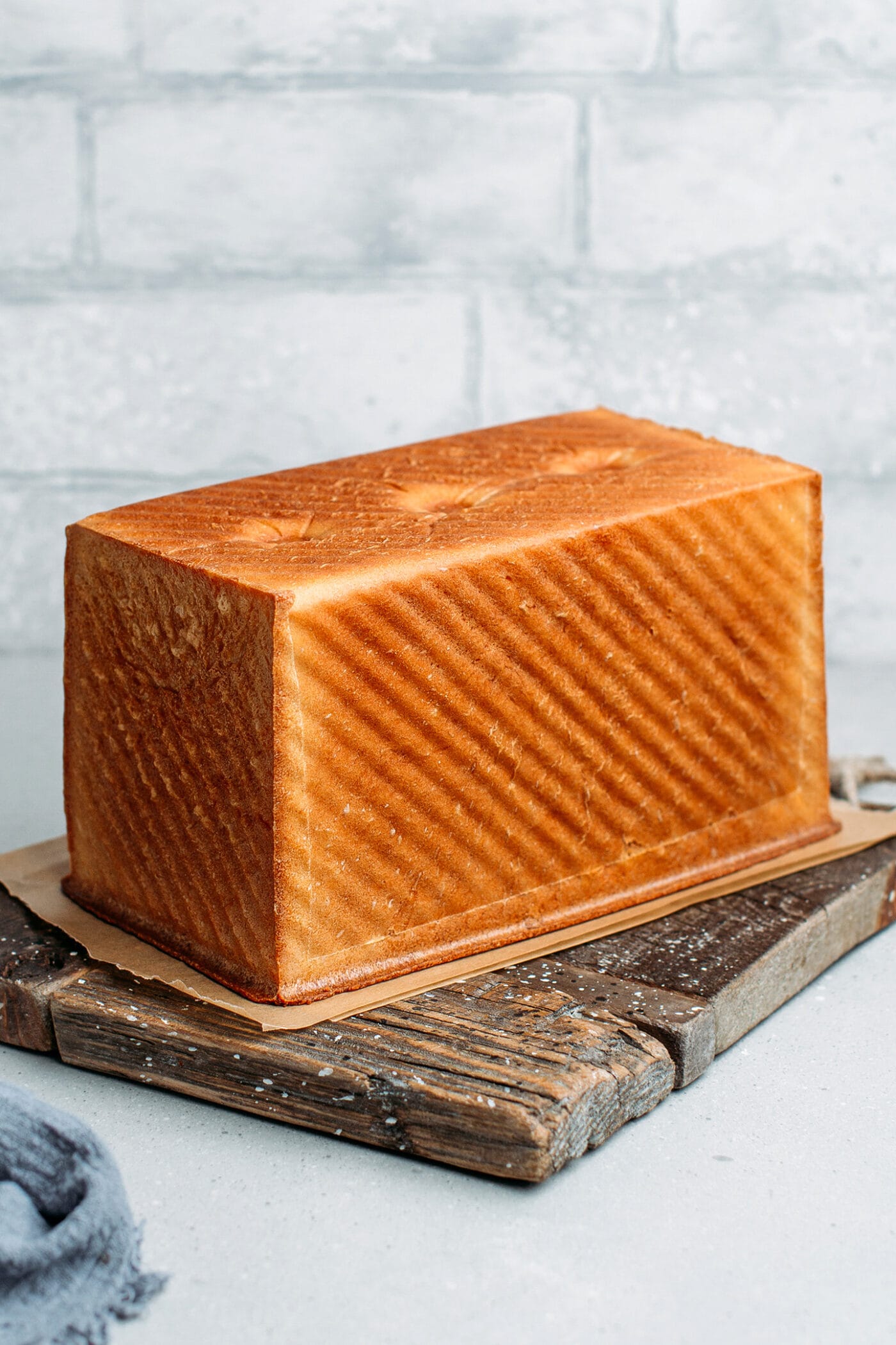 Loaf of Pullman bread on a wooden board.