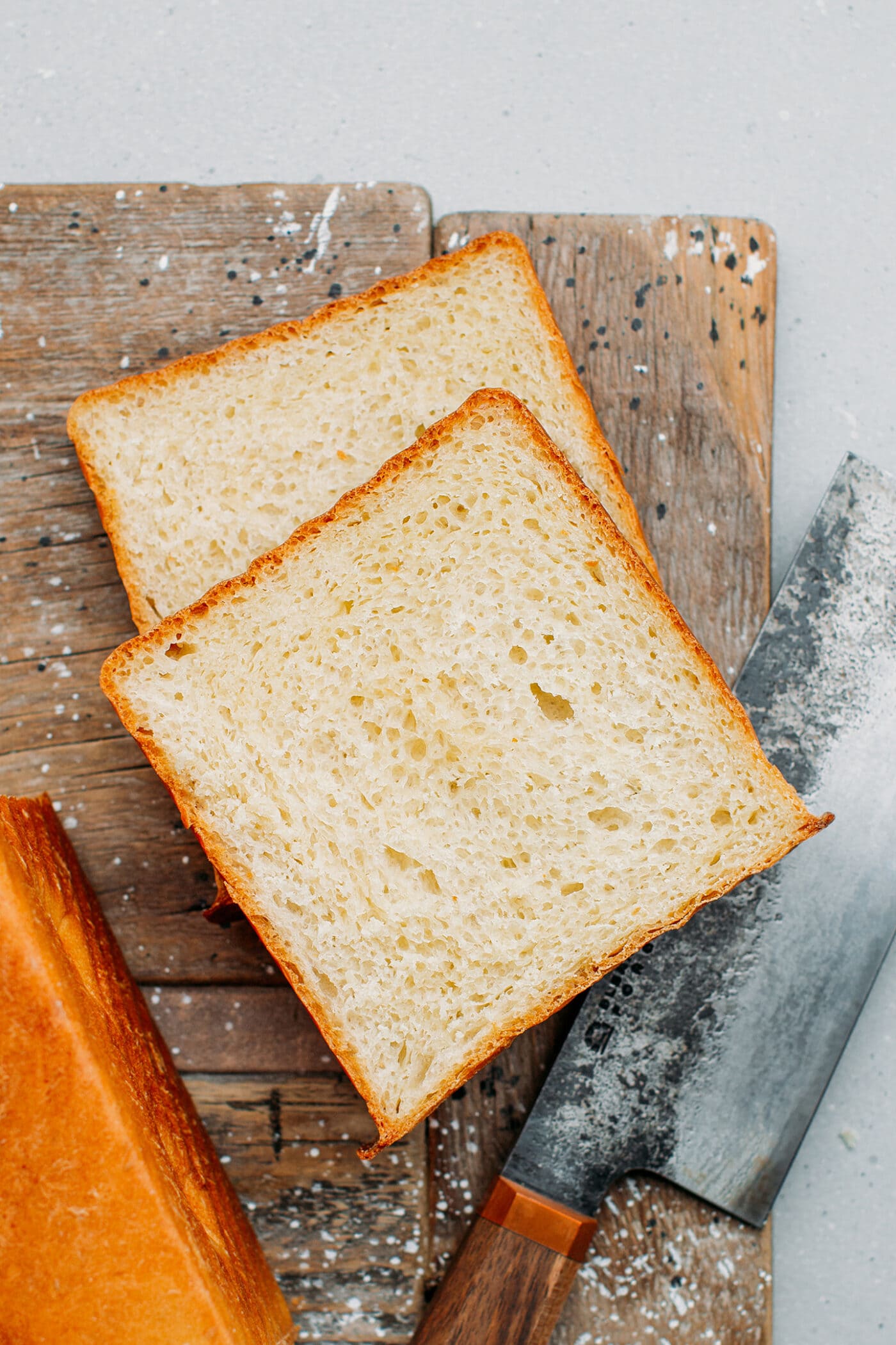 Two slices of sandwich bread on a cutting board.