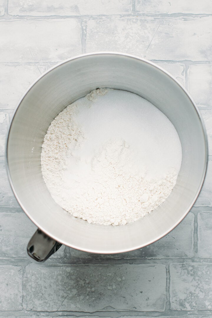 Flour, sugar, and salt in the bowl of a stand mixer.