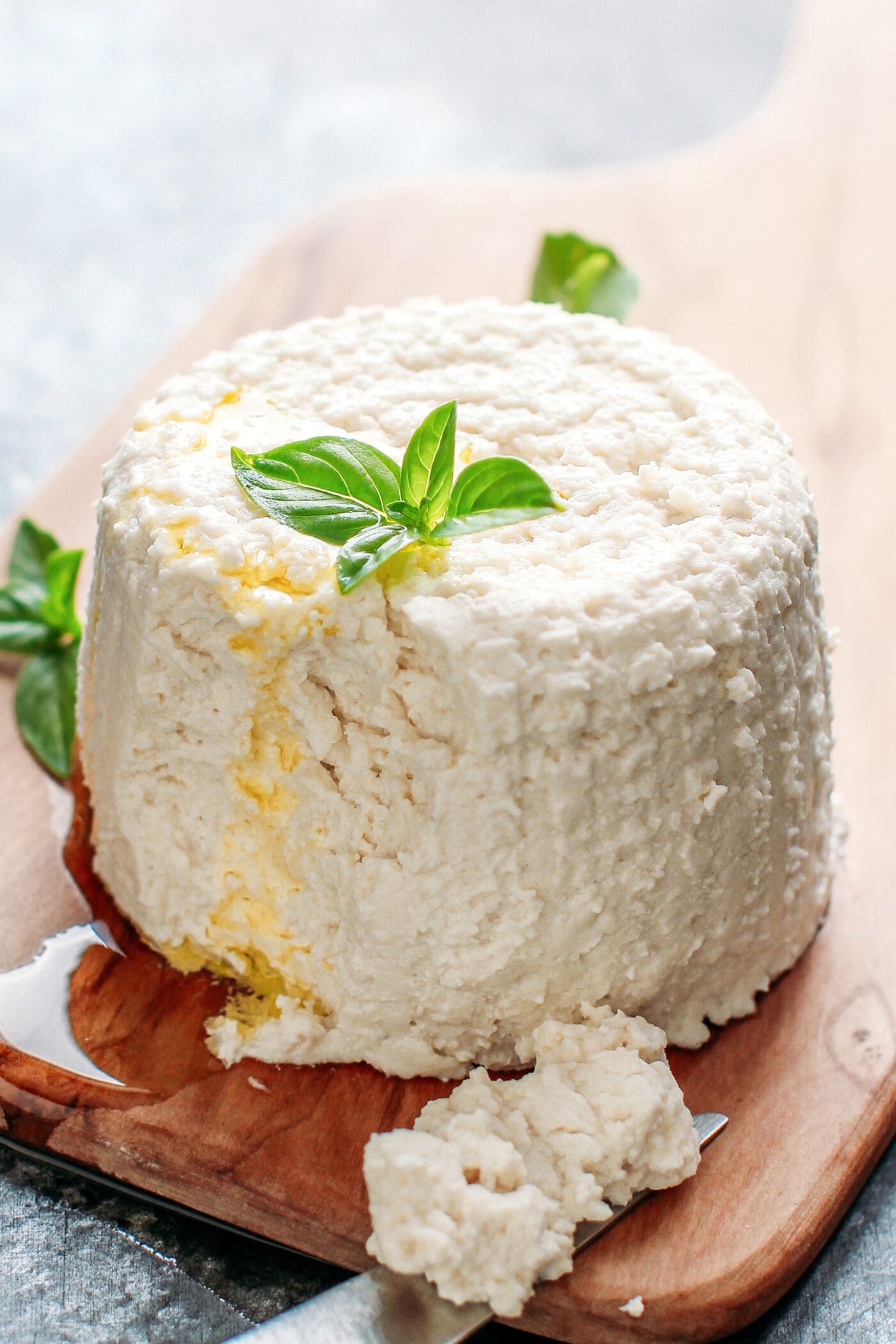 Ricotta drizzled with olive oil and topped with fresh basil.