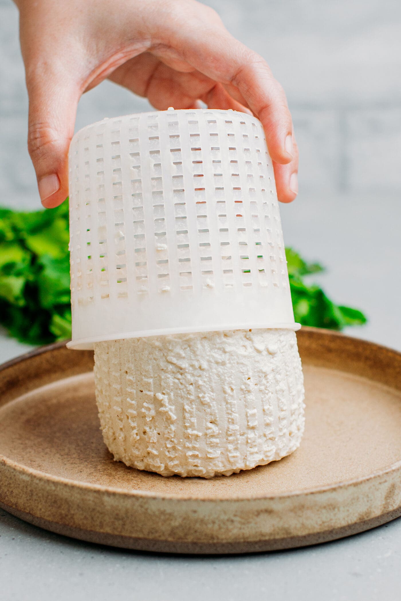 Removing ricotta from a mold.