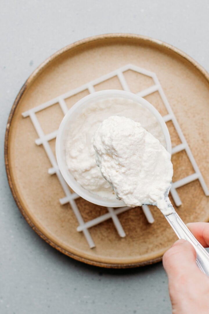 Transferring ricotta curds to a mold.