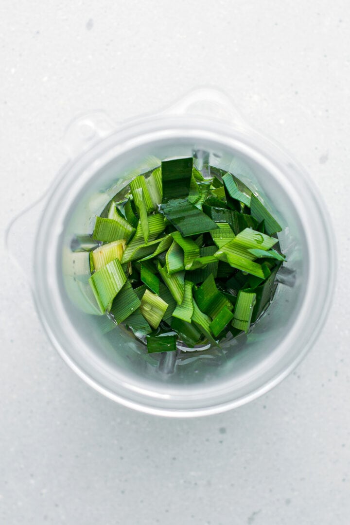 Chopped pandan leaves in a blender.