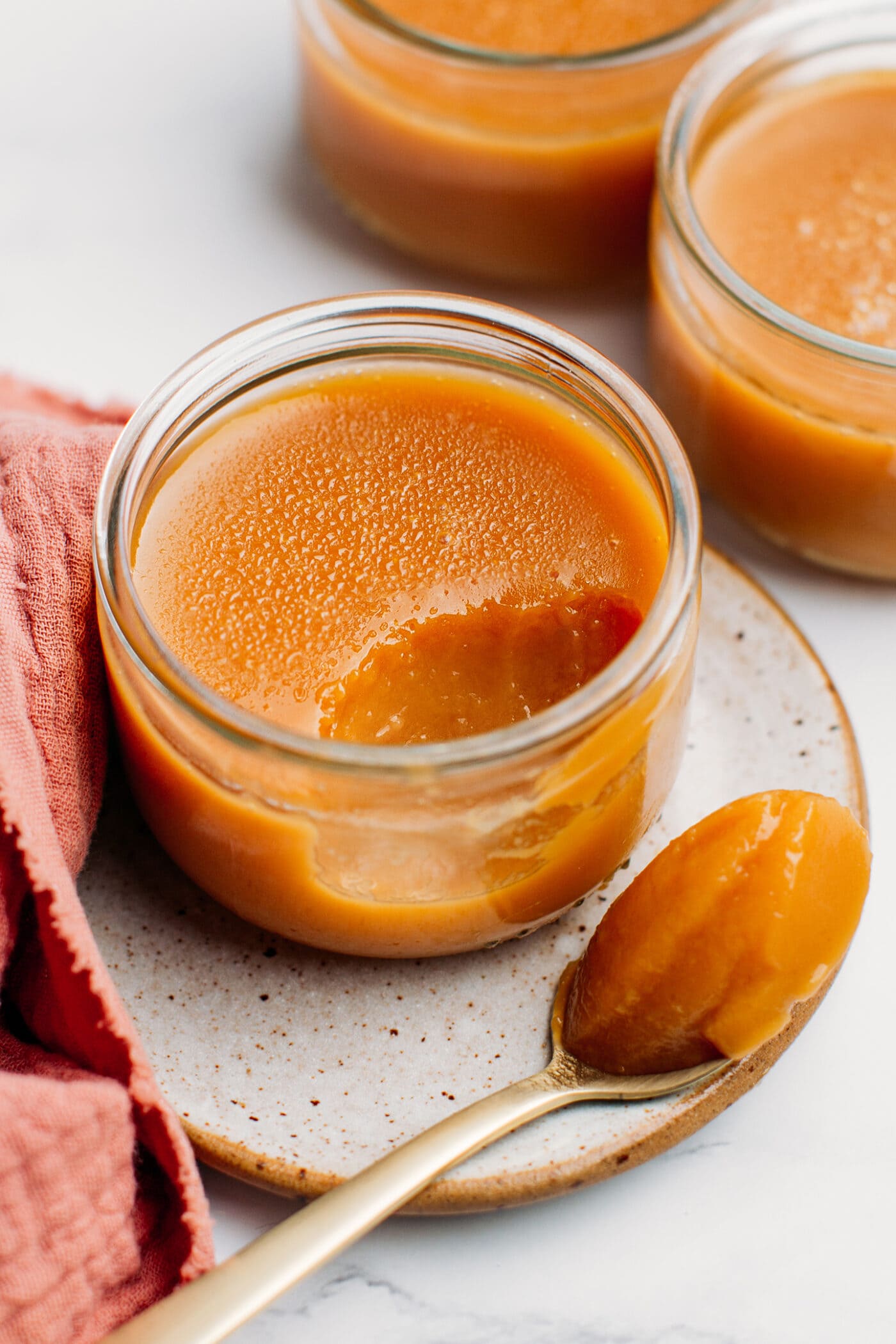 Caramel Pot de crème on a small plate.