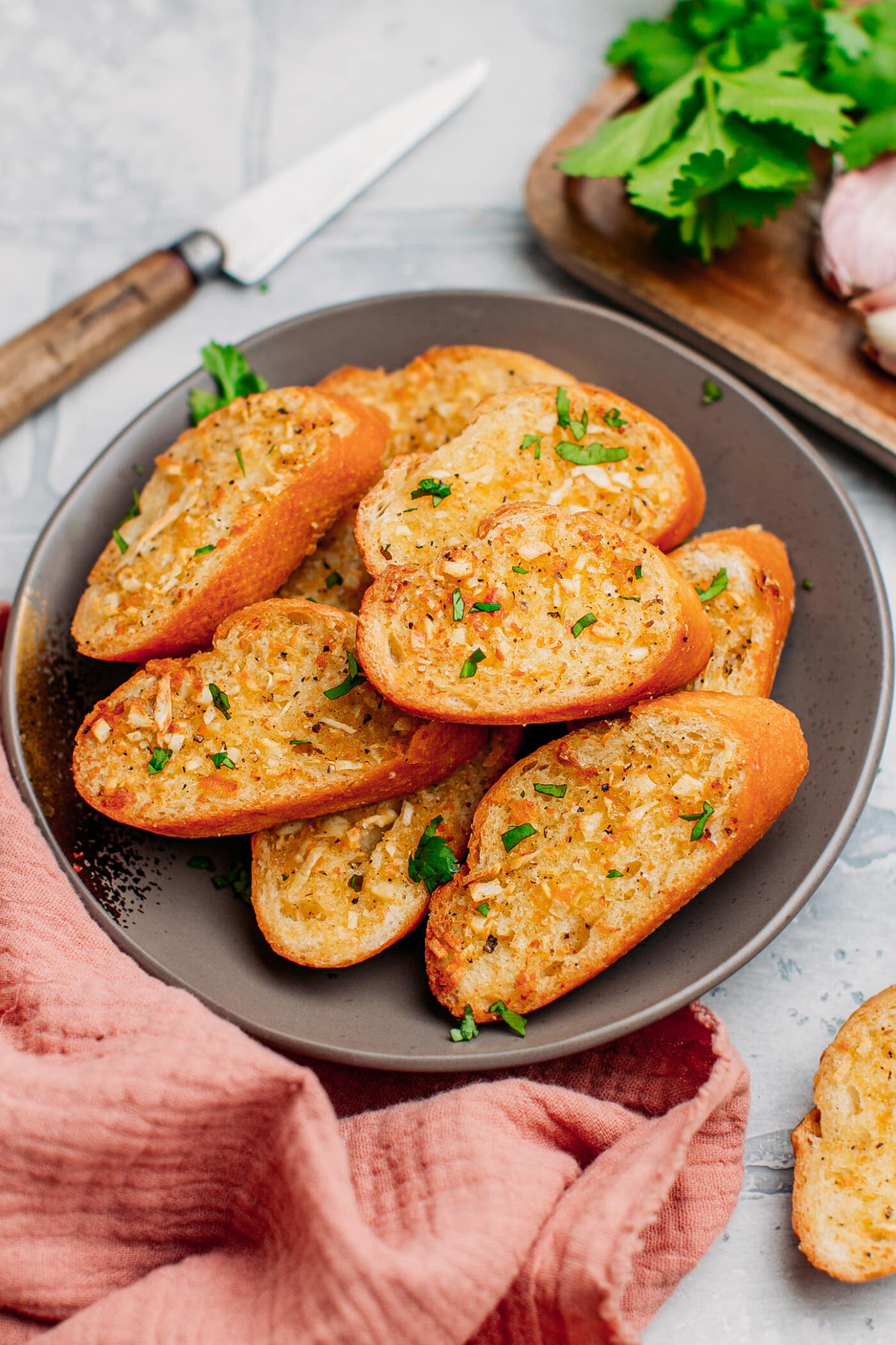 Garlic bread slices toppeed with chopped parsley.