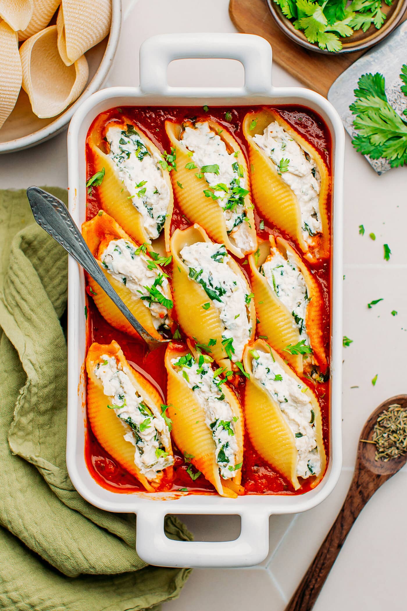 Stuffed shells with ricotta and tomato sauce in a baking dish.