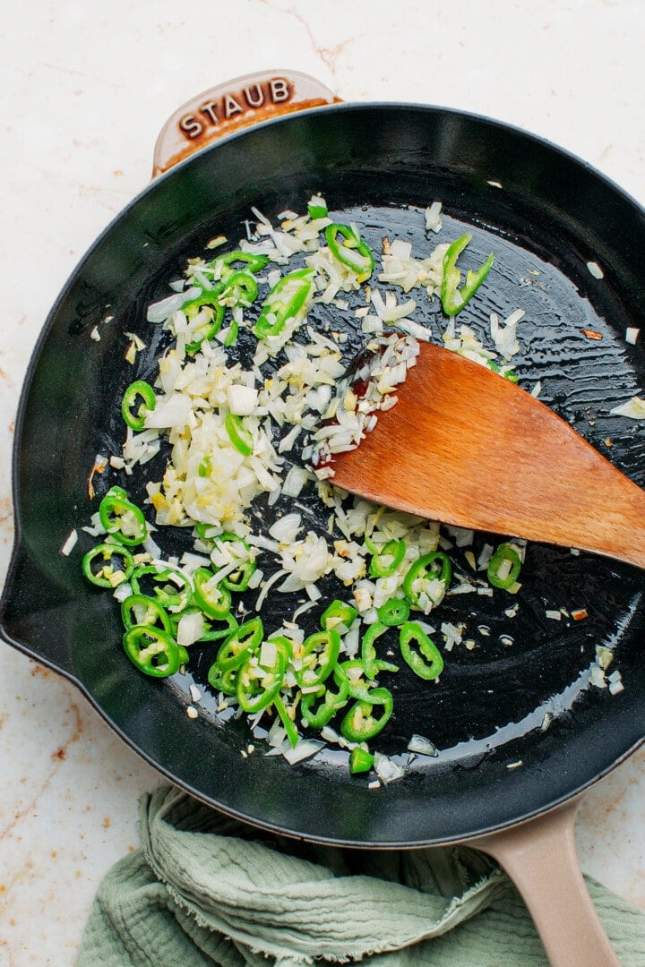 Garlic, onion, ginger, and jalapeno peppers in a skillet.