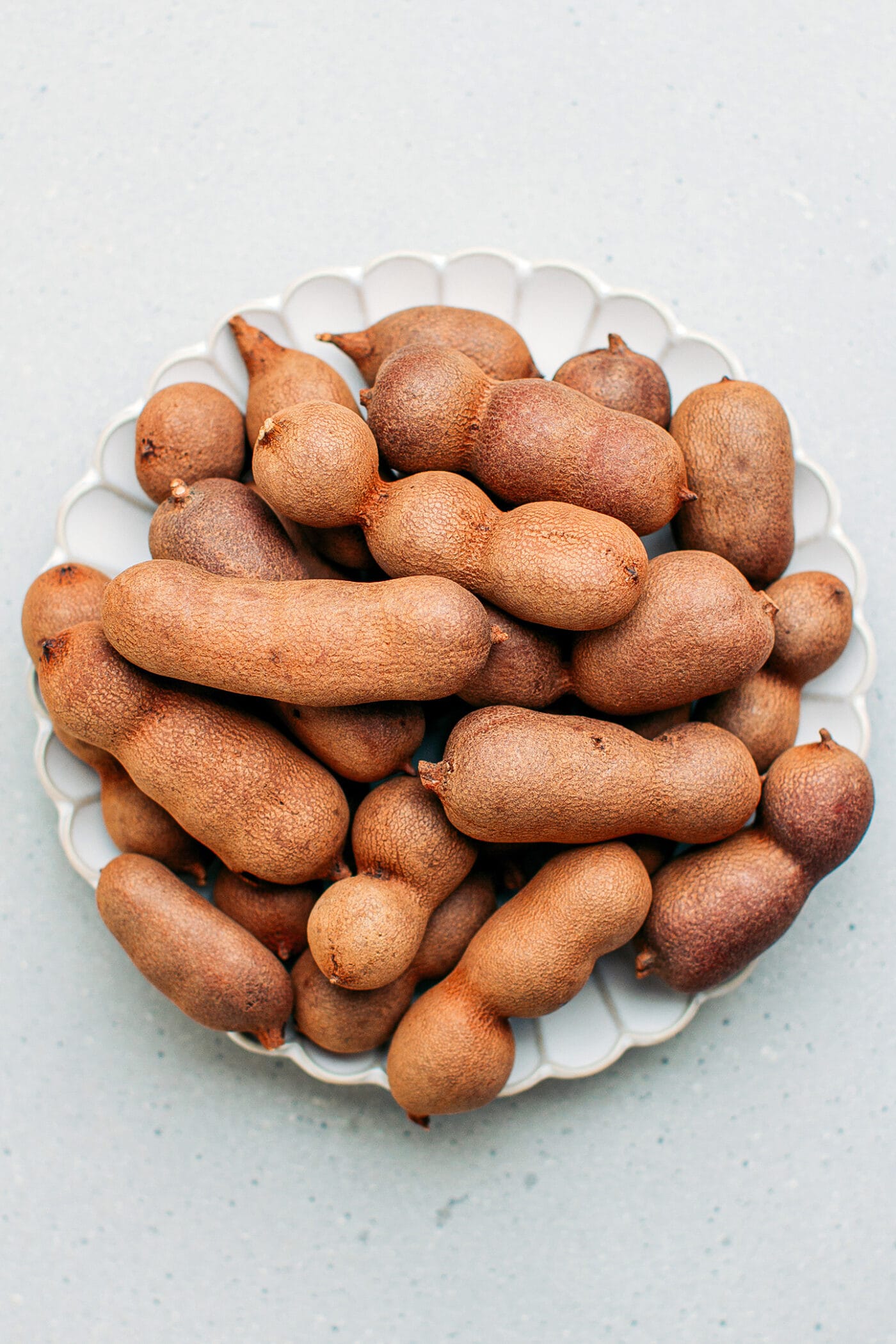 Tamarind pods on a small plate.