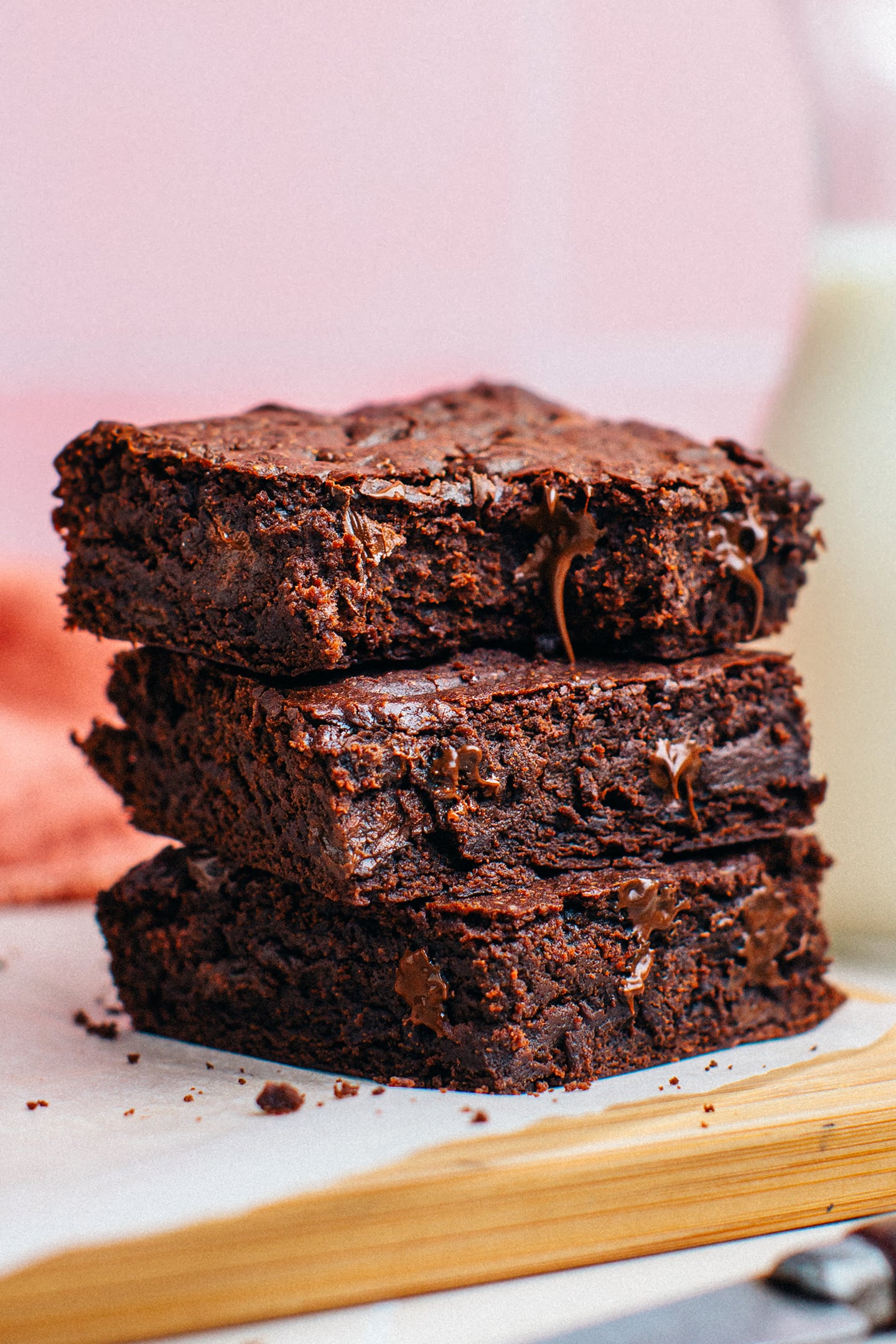 Stack of vegan brownies with chocolate chips.