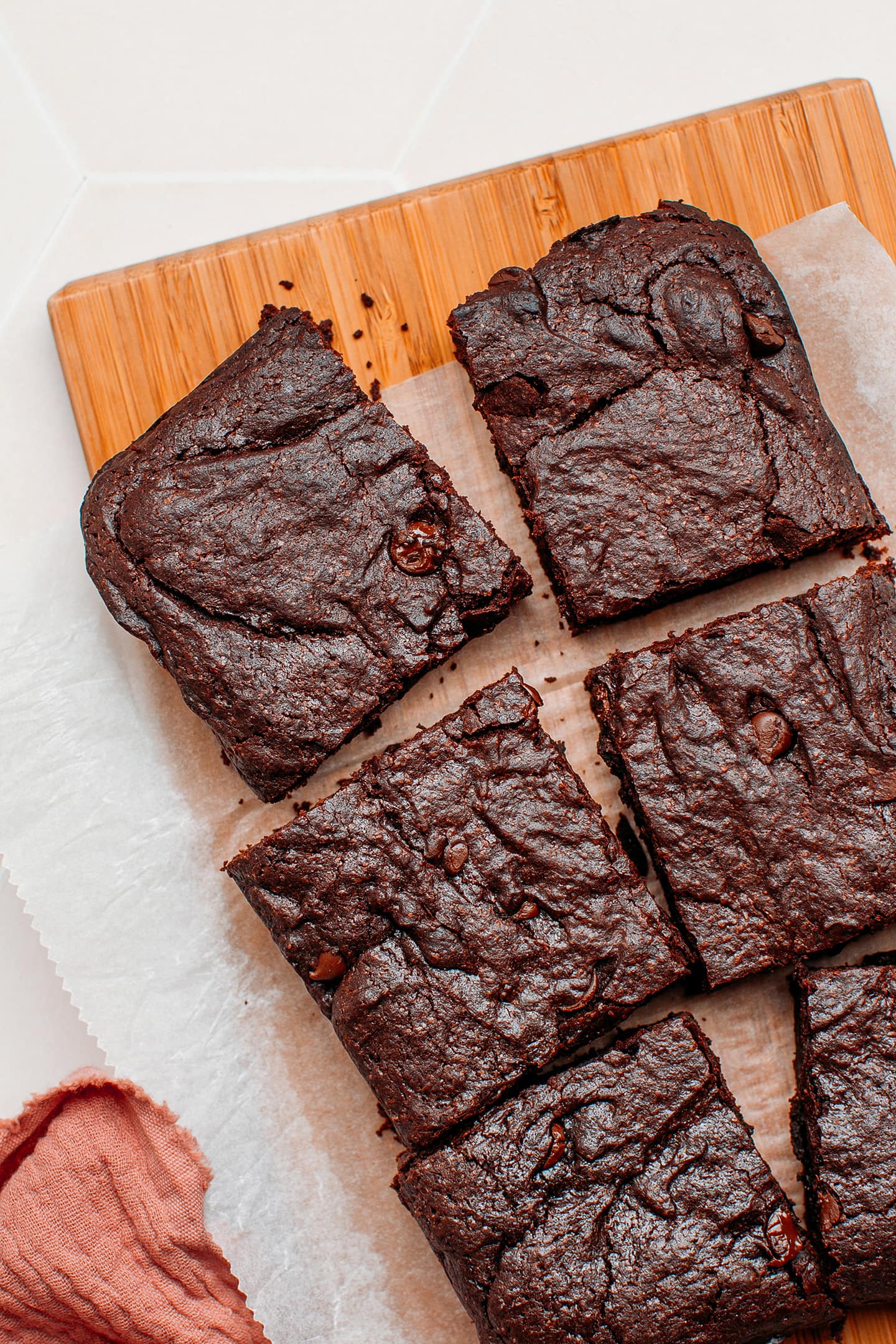 Slices of vegan brownie on a cutting board.
