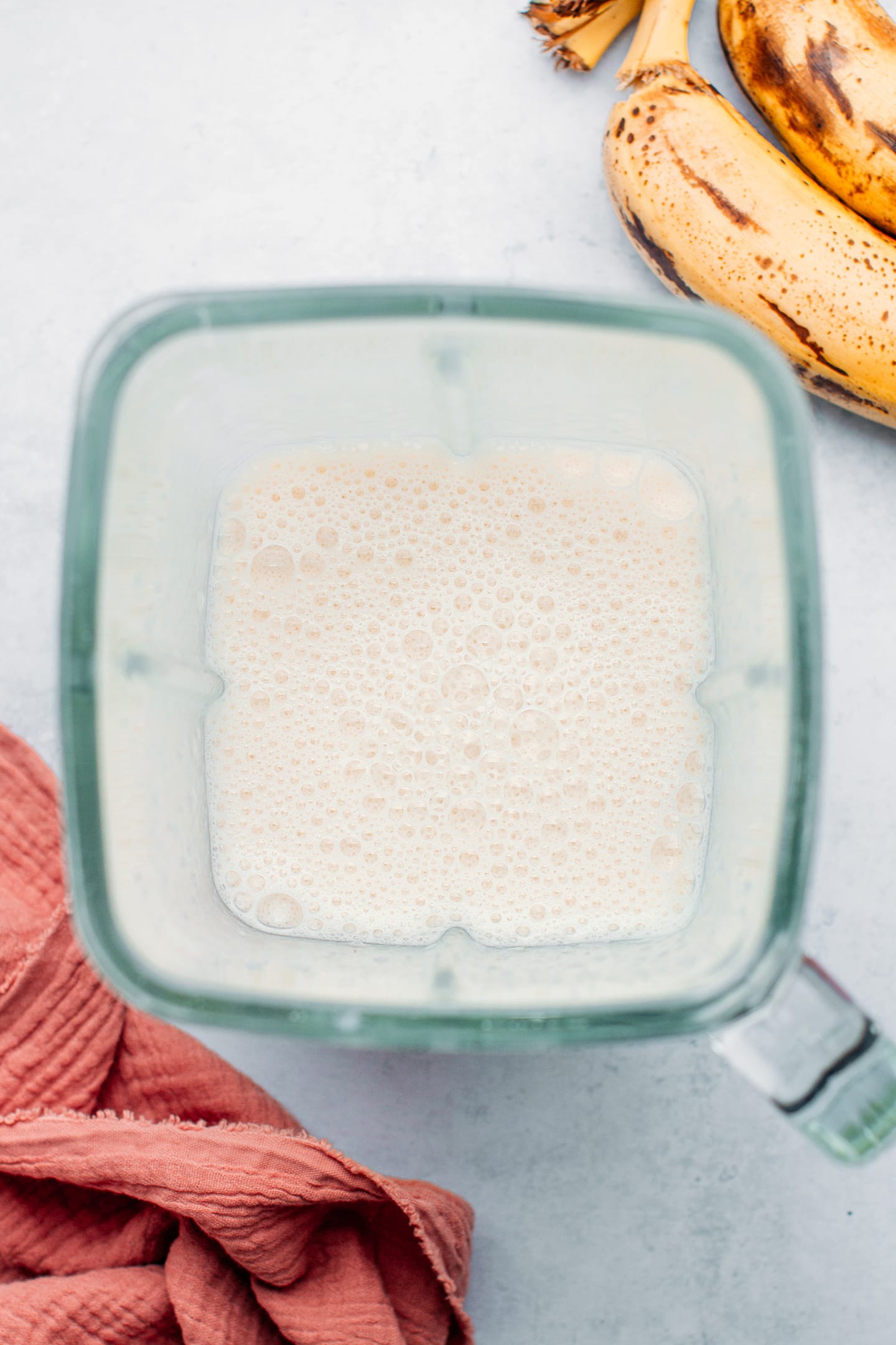 Banana blended with milk and sugar, in a blender.