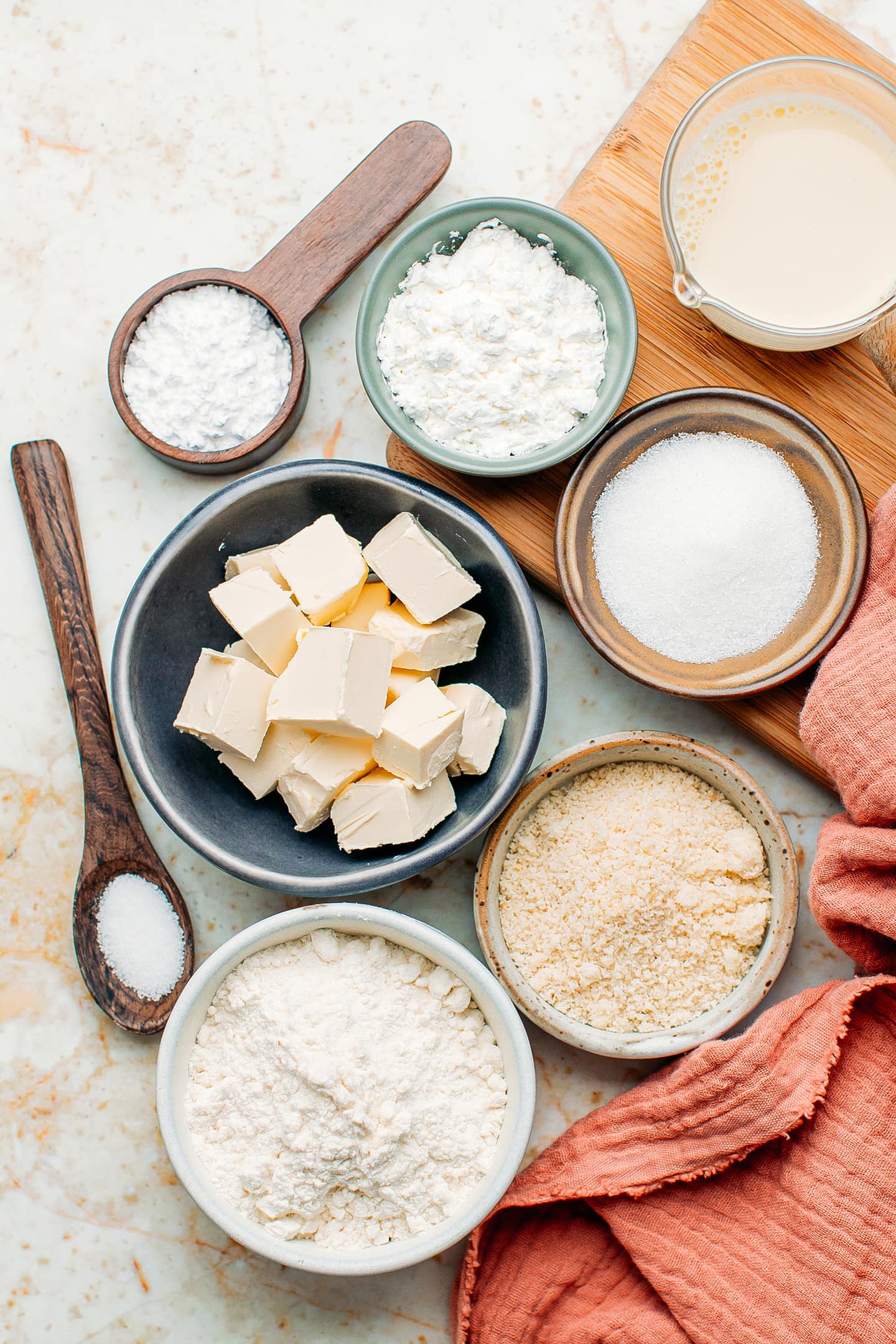 Ingredients like butter, flour, almond flour, cornstarch, and powdered sugar.