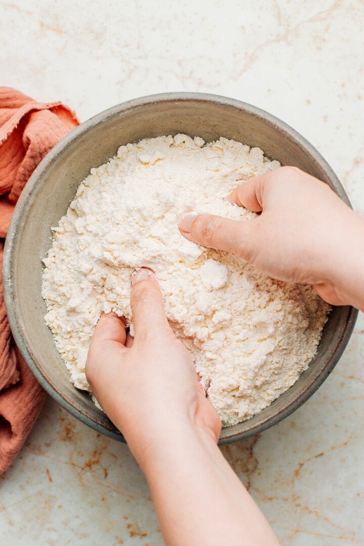 Sanding butter and flour in a mixing bowl.