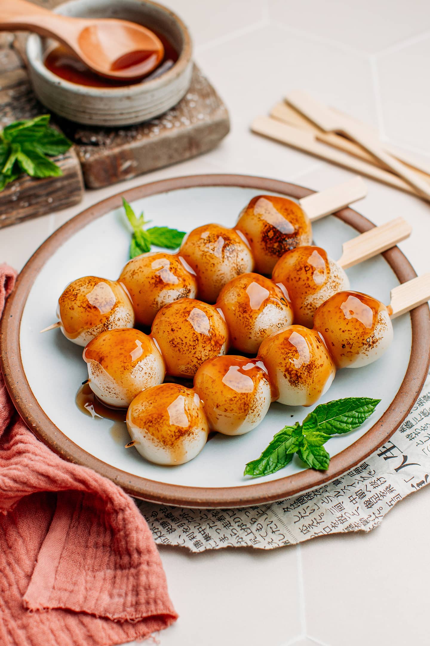 Dango on a plate with a sweet and salty glaze.