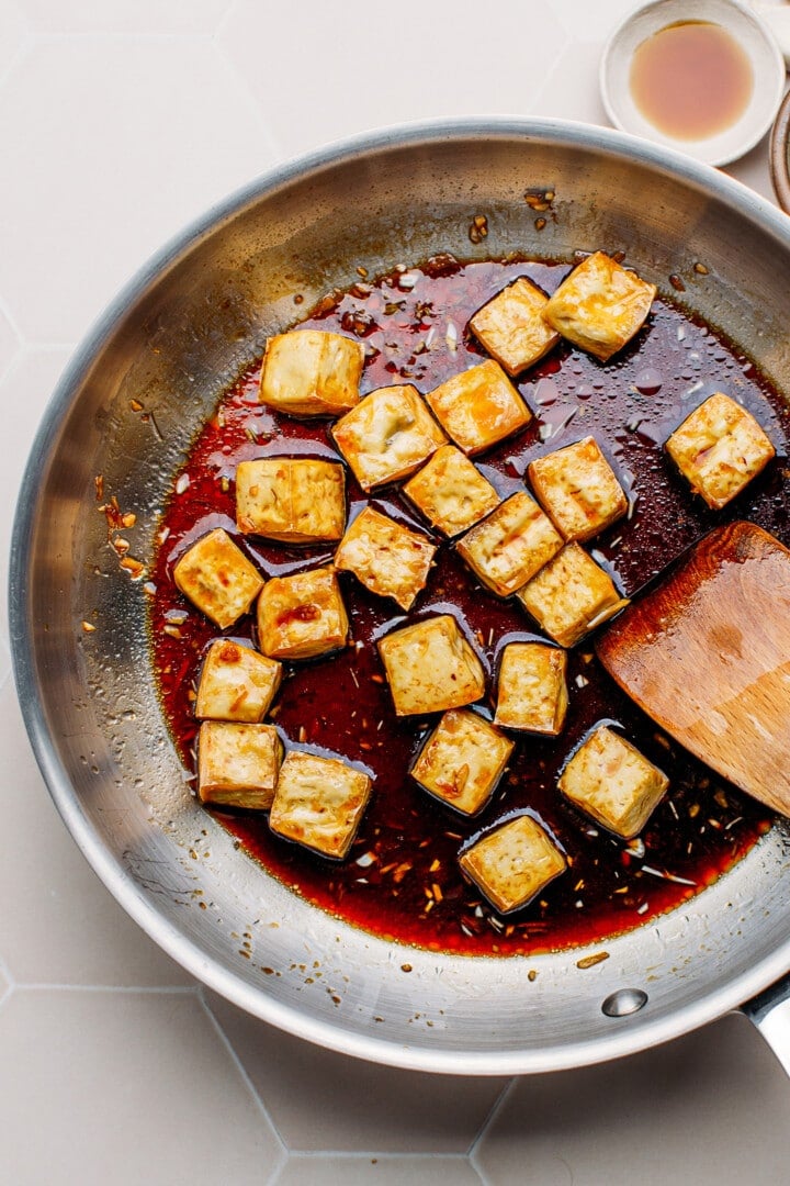 Simmering tofu in teriyaki sauce.