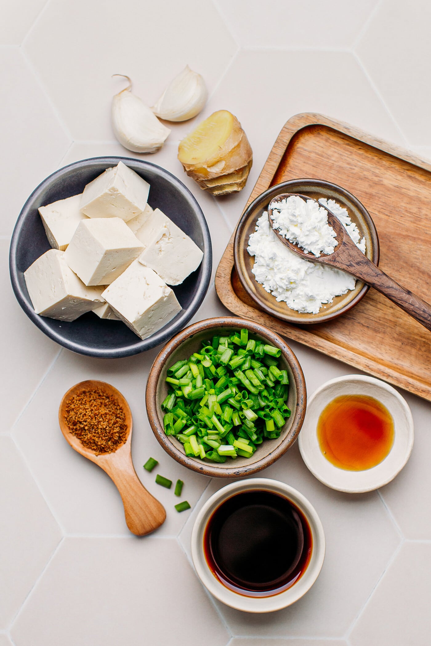 Ingredients like tofu, soy sauce, sesame oil, ginger, and garlic.