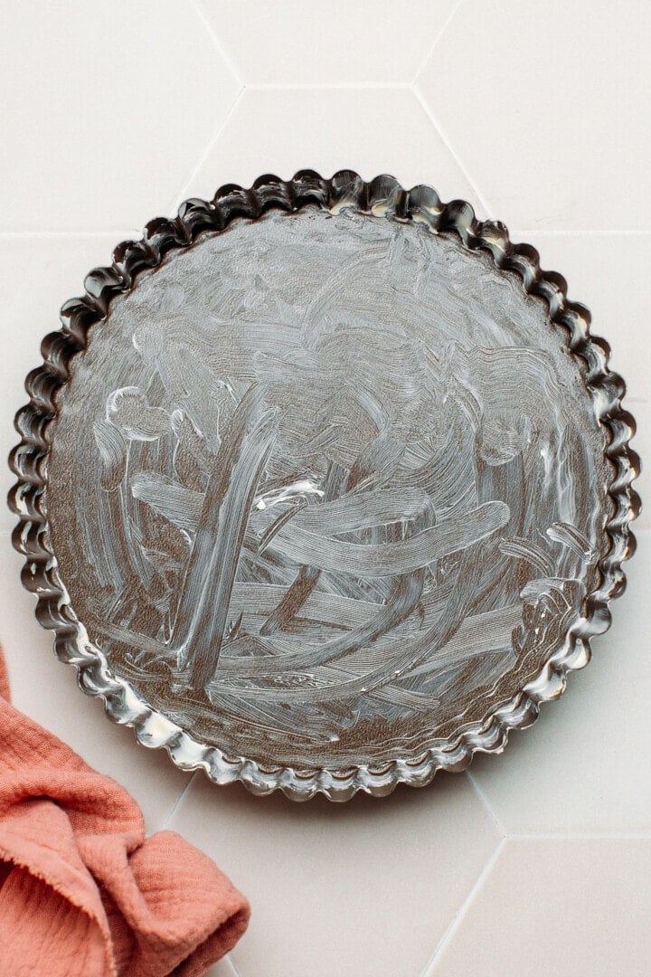 Pie pan greased with butter.
