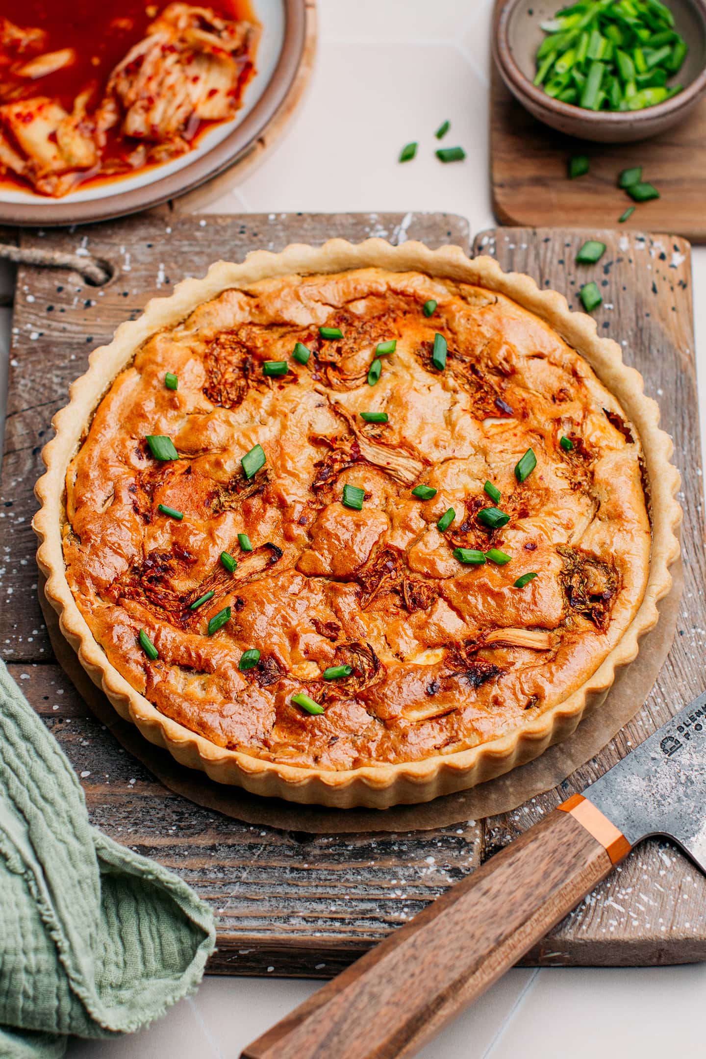 Kimchi quiche on a wooden board.