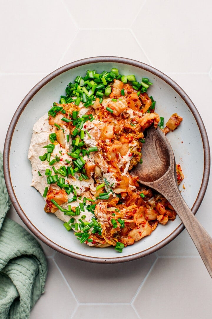 Stirring kimchi, green onions, and tofu cream.