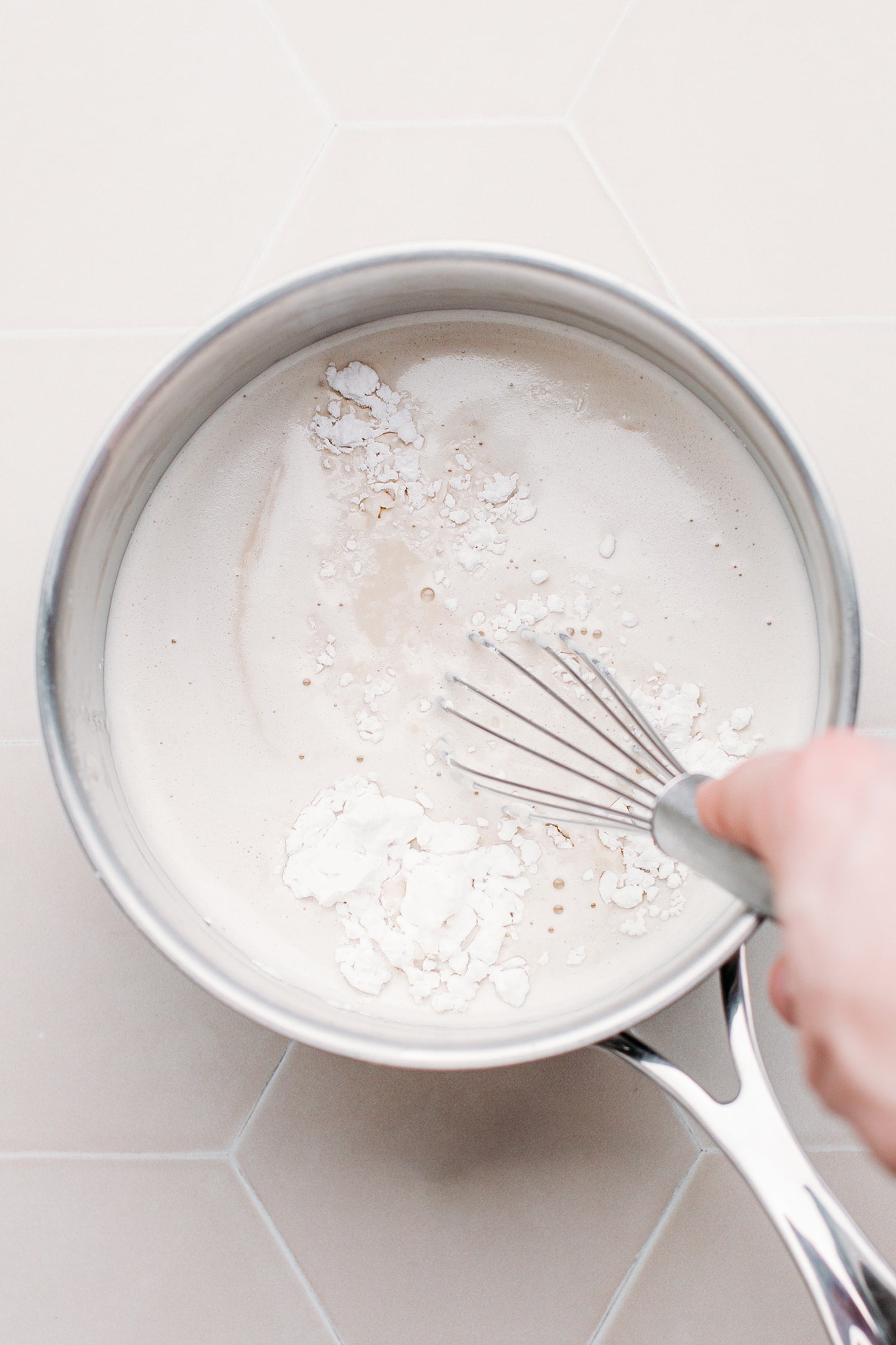 Whisking cheese sauce with tapioca starch.